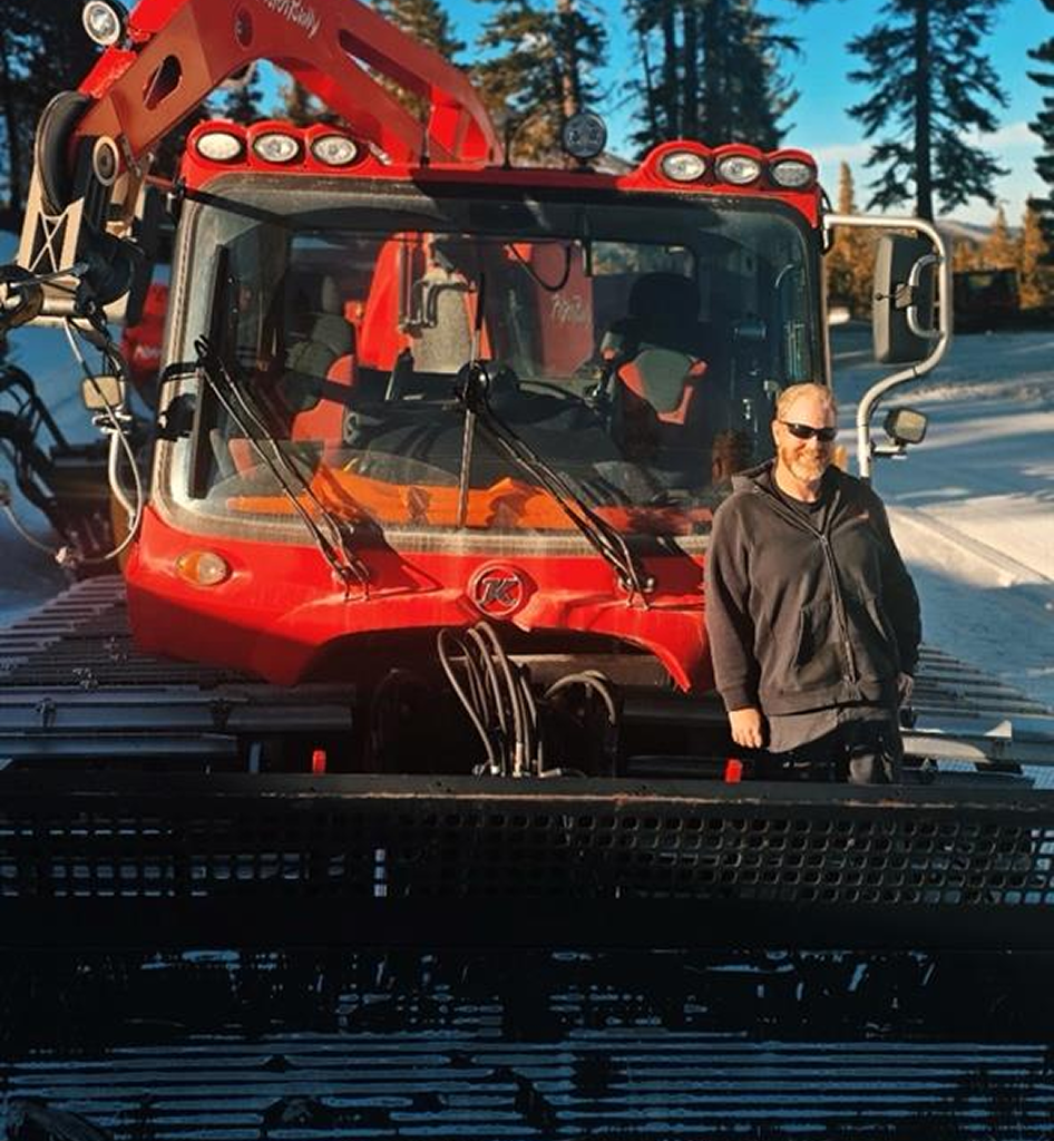 Aaron Fulton in front of a PistenBully at Mt Rose. 