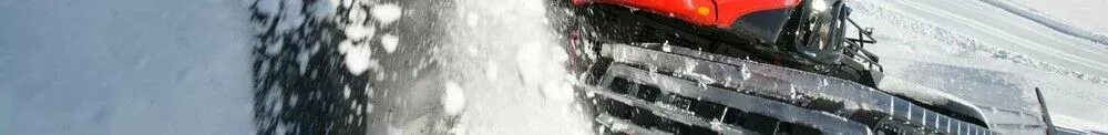 PistenBully 600 Polar pushes snow with the blade.